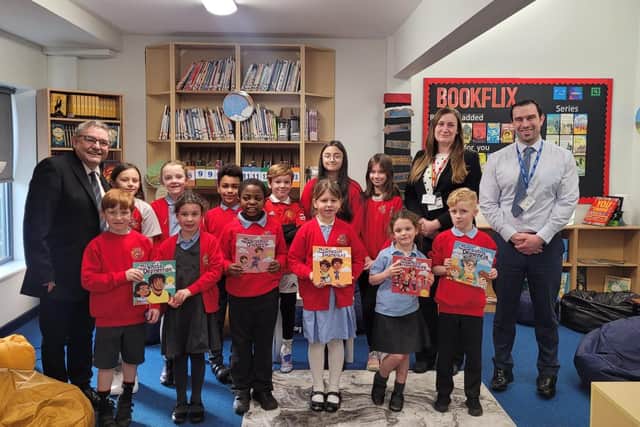 School pupils receive the new books from councillors Chris Ready and Laura Flynn