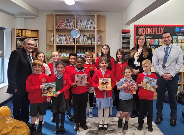 School pupils receive the new books from councillors Chris Ready and Laura Flynn