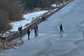 The youngsters were spotted playing on the icy canal