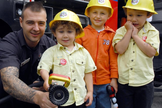 Wigan fire fighters visited the annual WOW Festival at Alexandra Park and fire fighter Danny Molyneux is pictured with Zak and Aaron Hajoui and Chance Heyes.