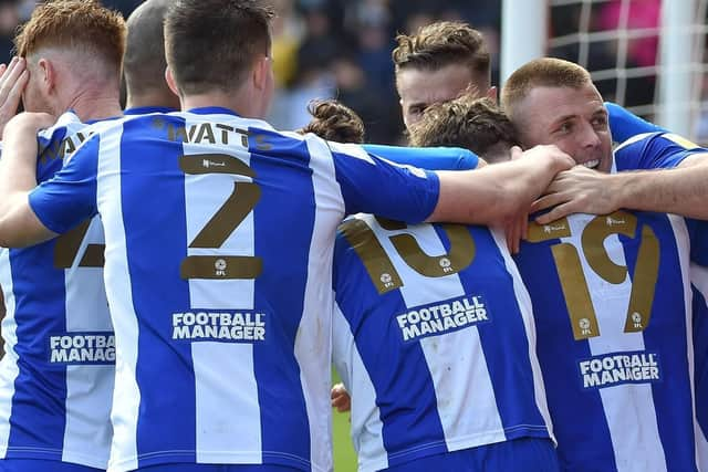 The Latics players celebrate at Lincoln