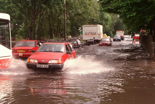 Traffic struggles along the flooded Warrington Road in Ashton-in-Makerfield.