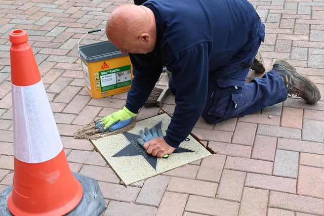 Wigan Council workers place the star outside Leigh Town Hall.