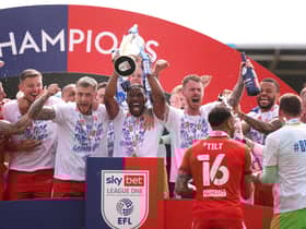 Tendayi Darikwa lifts the League One title for Latics