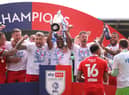 Tendayi Darikwa lifts the League One title for Latics