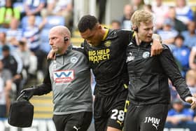 Josh Magennis is forced to limp from the field during the 1-1 draw at Reading