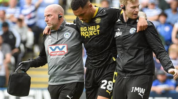 Josh Magennis is forced to limp from the field during the 1-1 draw at Reading