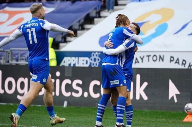 Scott Smith is congratulated after laying on the opening goal for Latics