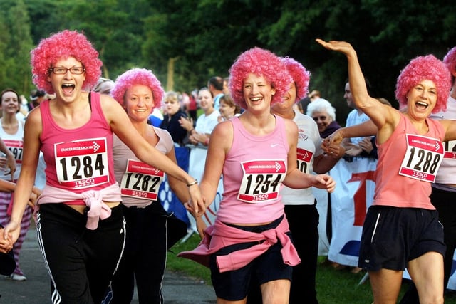 Participants in the annual Race For Life for Cancer Research UK in happy mood as they finish the course at Haigh Hall on Wednesday 28th of June 2006.