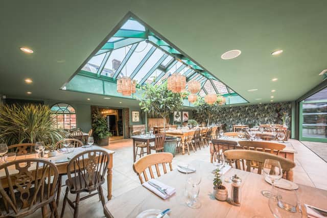 A conservatory-style restaurant opens onto a lush, landscaped terrace ideal for drinking and dining al fresco.