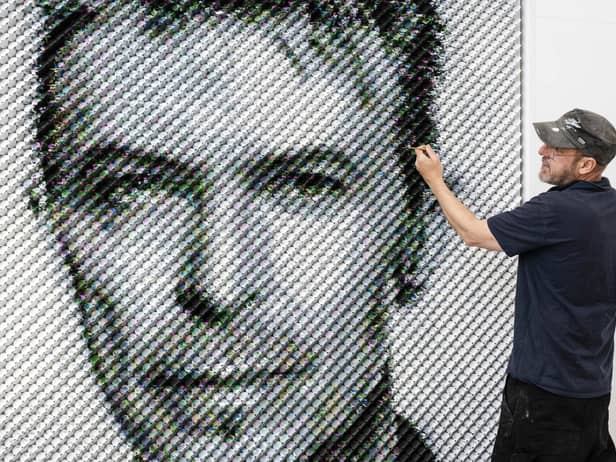 Artist Joe Black adds the finishing touches to a portrait of David Bowie made from over 8,500 guitar plectrums, commissioned by Sky Arts to celebrate Bowie topping a new definitive list of Britain's 50 most influential artists of the past 50 years