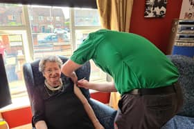 Resident Pat Taylor receiving her vaccination