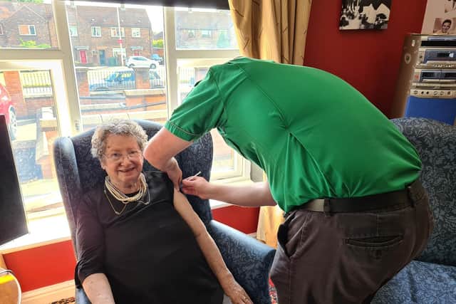 Resident Pat Taylor receiving her vaccination