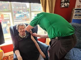 Resident Pat Taylor receiving her vaccination