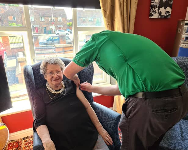 Resident Pat Taylor receiving her vaccination