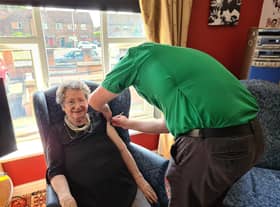 Resident Pat Taylor receiving her vaccination