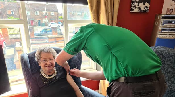 Resident Pat Taylor receiving her vaccination