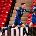 Sean McGurk (right) celebrates scoring for Latics against Manchester United at Old Trafford in the FA Youth Cup in February 2020