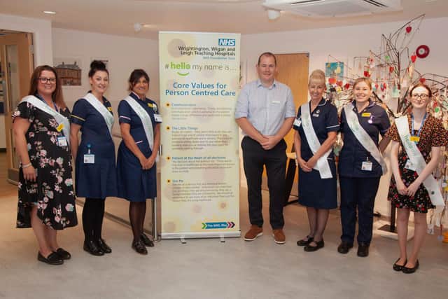 Chris Pointon, co-founder of the "Hello, my name is..." campaign, with staff at Wrightington Hospital