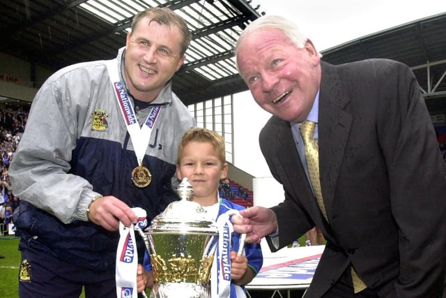 Paul Jewell and Dave Whelan share the moment with Dave Whelan's grandson Paul as Wigan Athletic lift the Division 2 championship trophy after beating Barnsley 1-0 with a Tony Dinning goal  on Saturday 3rd of May, the last day of the 2002/2003 season. 