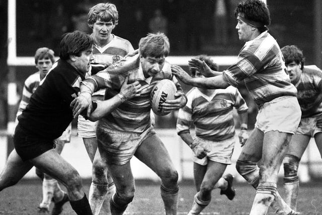 Wigan forward Mick Scott looks for a gap with Dennis Ramsdale and Howie Tamati in close support against Fulham in a league match at Central Park on Sunday 18th of March 1984. Wigan won the match 38-18.