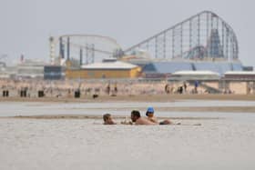 People enjoy the warm weather on the Blackpool Beach (Photo by Anthony Devlin/Getty Images)