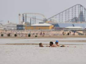 People enjoy the warm weather on the Blackpool Beach (Photo by Anthony Devlin/Getty Images)