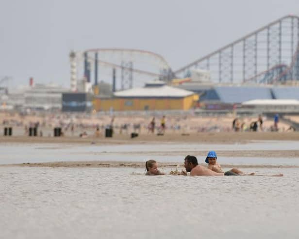 People enjoy the warm weather on the Blackpool Beach (Photo by Anthony Devlin/Getty Images)