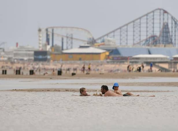 People enjoy the warm weather on the Blackpool Beach (Photo by Anthony Devlin/Getty Images)