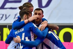 Jonny Smith is mobbed after scoring Latics' second goal against Bristol Rovers