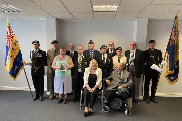 Pam Gilligan, from Compassion in Action, with veterans from the Wigan borough
