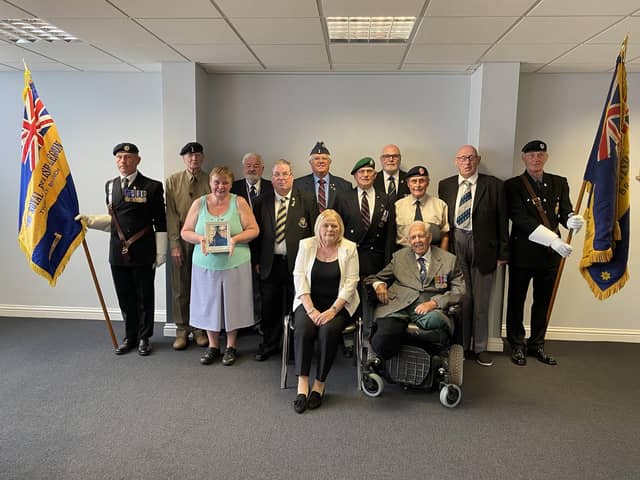 Pam Gilligan, from Compassion in Action, with veterans from the Wigan borough