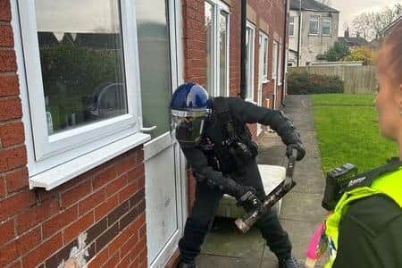 Police raiding the property in Leigh