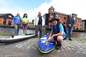 Cancer survivor Mark Rigby marks ten-years since being diagnosed with breast cancer with a Greater Good Epic Paddle, pictured at the start of the challenge at Wigan Pier, from left, Linda Rigby, Helen Matthews from SUP UK who will paddleboard with Mark on some of the days, Norman Rigby, Mark Rigby (front) and David Adams show their support.