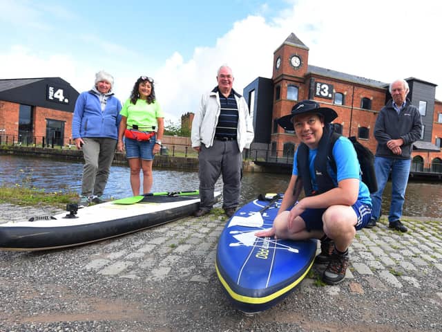 Cancer survivor Mark Rigby marks ten-years since being diagnosed with breast cancer with a Greater Good Epic Paddle, pictured at the start of the challenge at Wigan Pier, from left, Linda Rigby, Helen Matthews from SUP UK who will paddleboard with Mark on some of the days, Norman Rigby, Mark Rigby (front) and David Adams show their support.