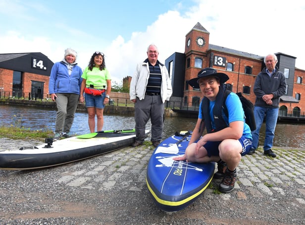 Cancer survivor Mark Rigby marks ten-years since being diagnosed with breast cancer with a Greater Good Epic Paddle, pictured at the start of the challenge at Wigan Pier, from left, Linda Rigby, Helen Matthews from SUP UK who will paddleboard with Mark on some of the days, Norman Rigby, Mark Rigby (front) and David Adams show their support.