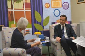 Volunteer asking Josh Simons questions on behalf of Age UK Wigan Borough's customer.