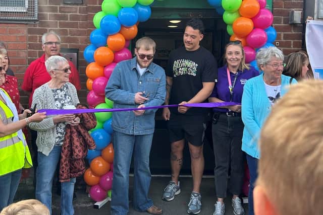 Alex Moore cuts the ribbon held by Tyler Dupree, declaring the new family hub at Clifton Street, Worsley Mesnes, open