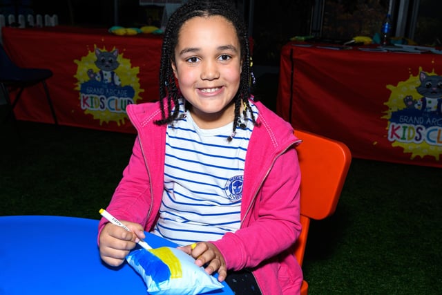 Eight-year-old Bella Banks decorates her sculpture