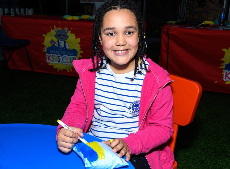 Eight-year-old Bella Banks decorates her sculpture