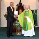 Phil Livesey receives his Benemerenti Medal from Fr Kevin