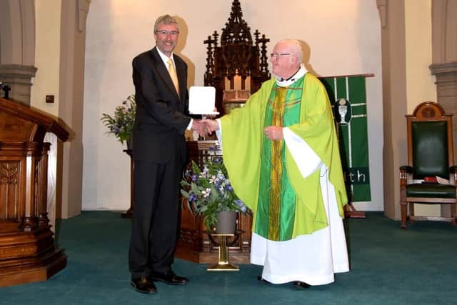Phil Livesey receives his Benemerenti Medal from Fr Kevin