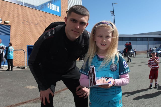 Brad O'Neill has a photo with a young fan.