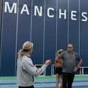 Keely Hodgkinson has a chat with coaches Jenny Meadows and Trevor Painter during a training session at Sport City, Manchester