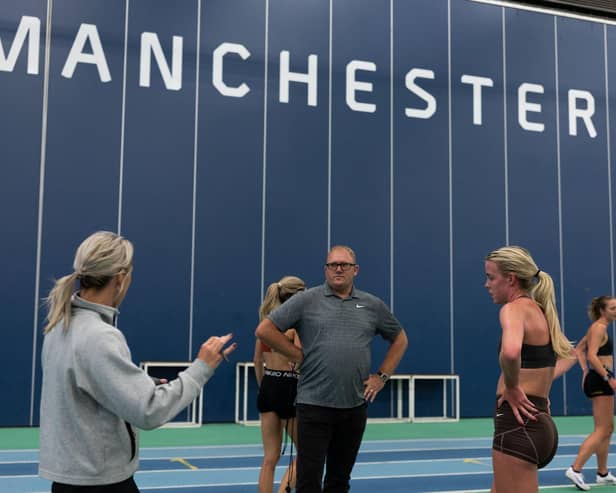Keely Hodgkinson has a chat with coaches Jenny Meadows and Trevor Painter during a training session at Sport City, Manchester