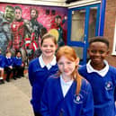 Pupils at St Johns CE Primary School with the superhero mural