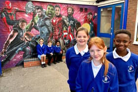 Pupils at St Johns CE Primary School with the superhero mural