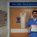 Wigan Infirmary ICU nurse Mark Ainscough with his children's book, Freddie and the Magic Heart