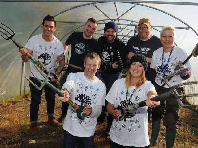 Staff from clothing and footwear brand Timberland, help tidy up the school garden, cleaning up the over-grown polytunnel and donate £2,000 of equipment for the forest school project at St Marks Primary, Newtown. Back row from left,:Timberland staff members Ben Everett-Li, Lee Geary, Thomas Miller, Steve Harper and class teacher Sarah Harper. Front row from left: Craig Tabiner and teaching assistant Joanne Dove