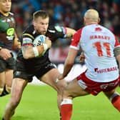 Mike Cooper has returned to Wigan's 21-man squad for the trip to Huddersfield